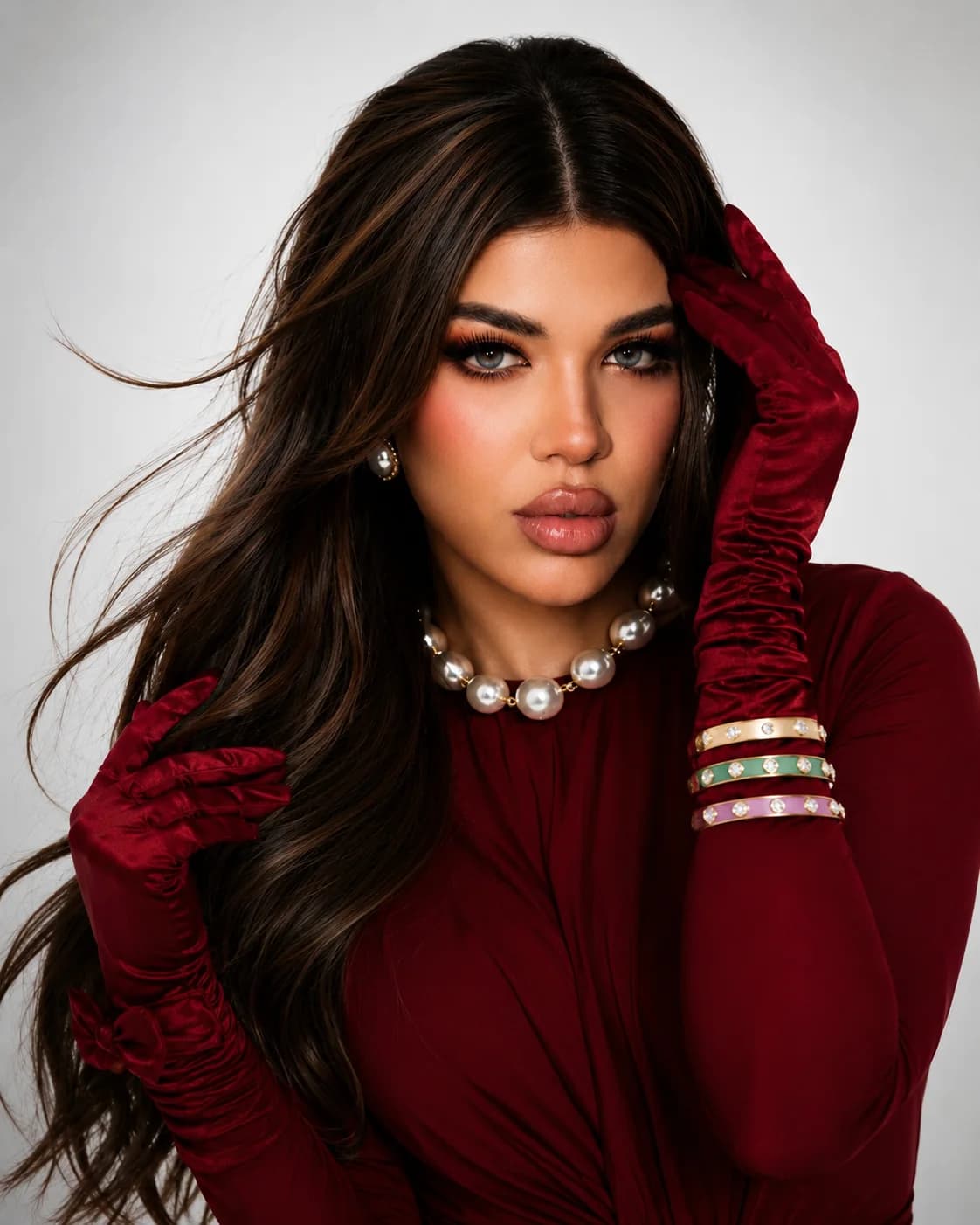 Almas Anfar Kathuria wearing red gloves in an editorial portrait